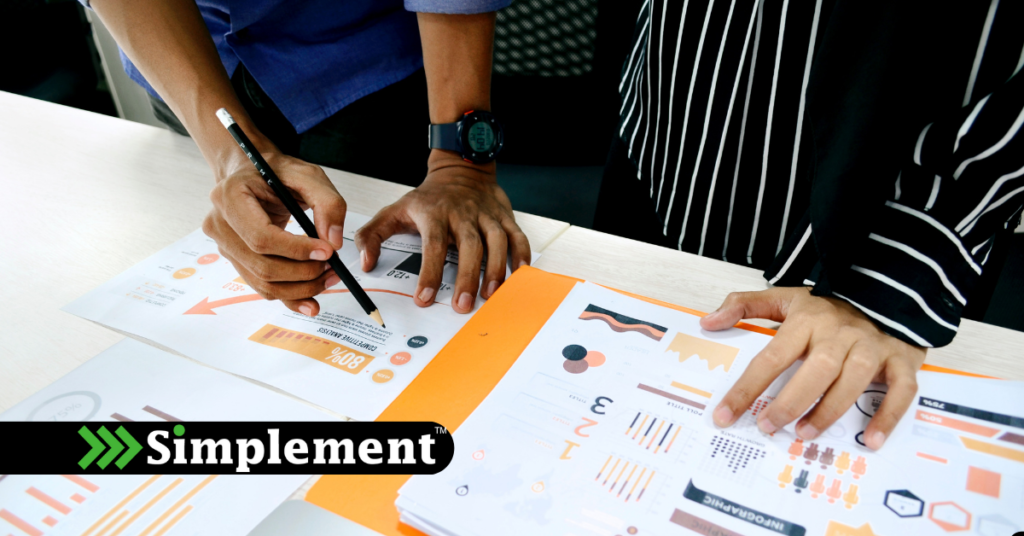 analyzing data on a desk, simplement logo